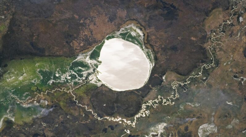 Lake-filled impact crater in Africa transforms into a giant silver ‘mirror’ via rare phenomenon — Earth from space